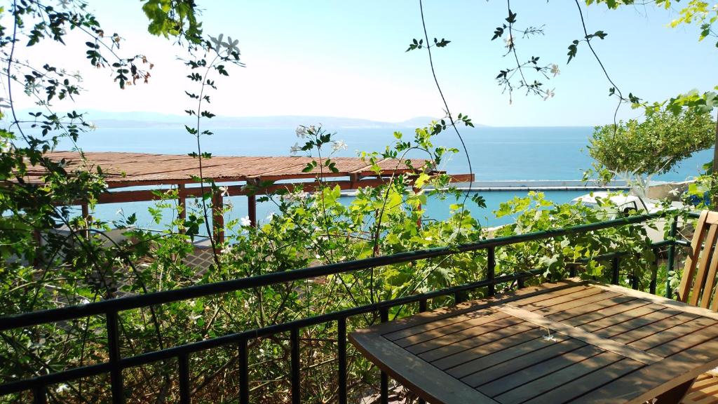 a balcony with a table and a view of the ocean at Loggia Two in Agia Galini
