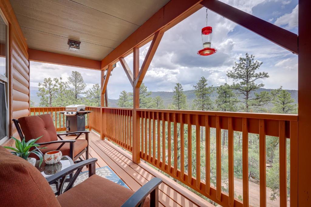 a screened in porch with a view of the mountains at Jemez Springs Cabin with Deck and Mountain Views! in Jemez Springs