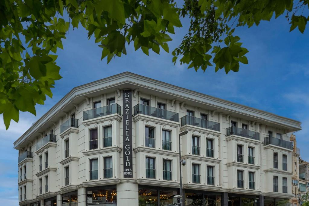 a white building with a sign on it at Graziella Gold Hotel in Istanbul