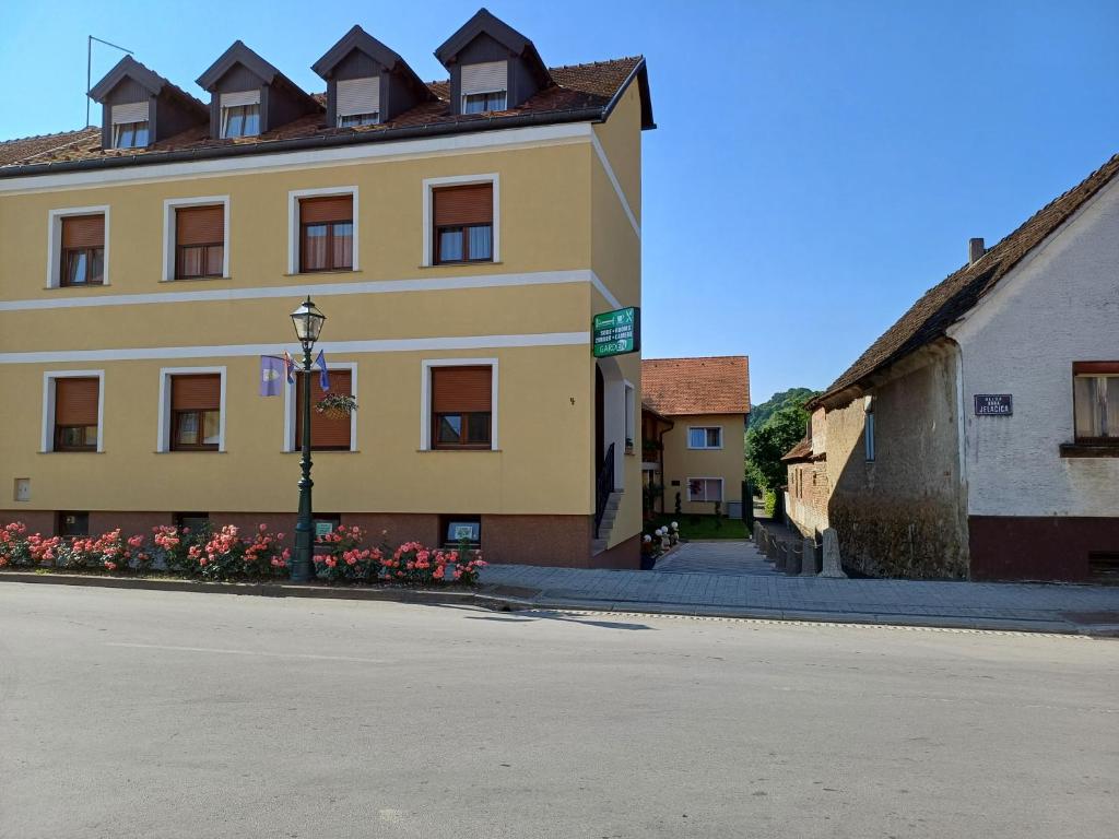 a large yellow building on a street next to a building at Garden in Varaždinske Toplice