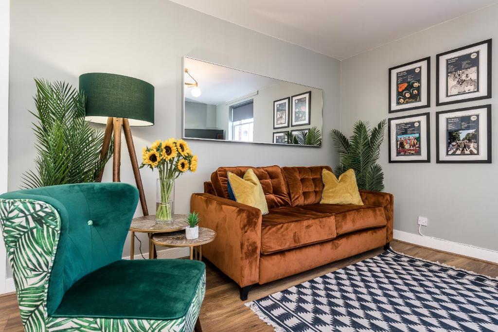 a living room with a brown couch and a mirror at Host & Stay - Canning Quarters in Liverpool