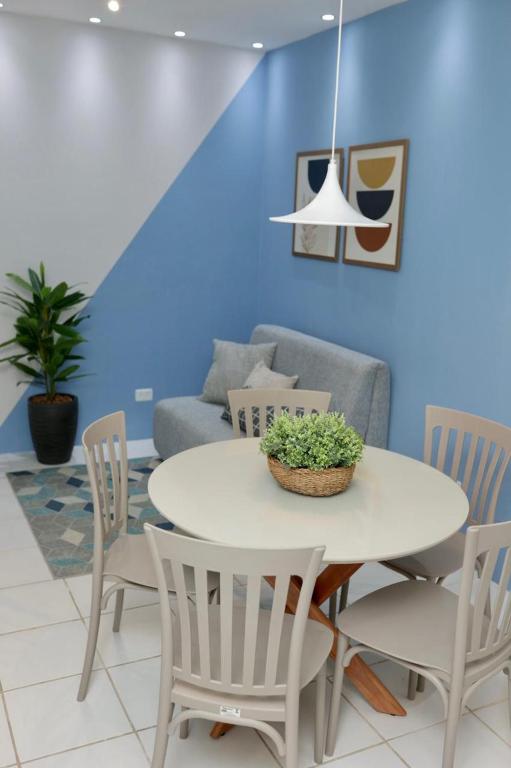 a dining room with a white table and chairs at Flat na Fazenda Monte Castelo Gravatá Sairé - Mod 12 - Flat 9 in Gravatá