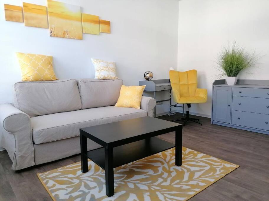 a living room with a couch and a table at cozy City Apartment in Senftenberg