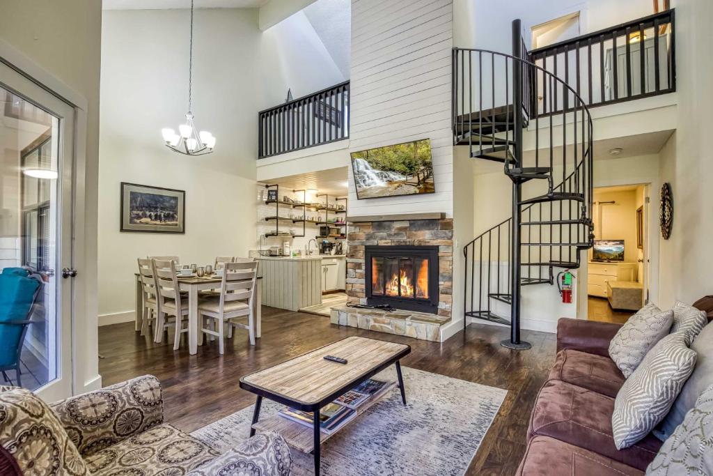 a living room with a couch and a fireplace at Gatlinburg Mountain Townhome with Pool Access! in Gatlinburg