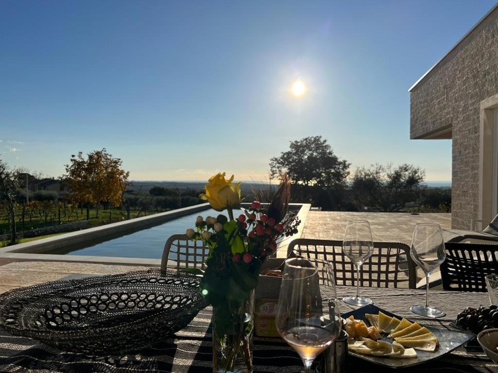 a table with a vase of flowers on top of a table at Villa Claudia in Kaštelir