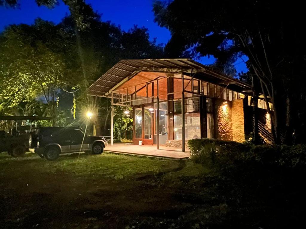 a small house with a car parked outside at night at Olosiva Oasis in Arusha