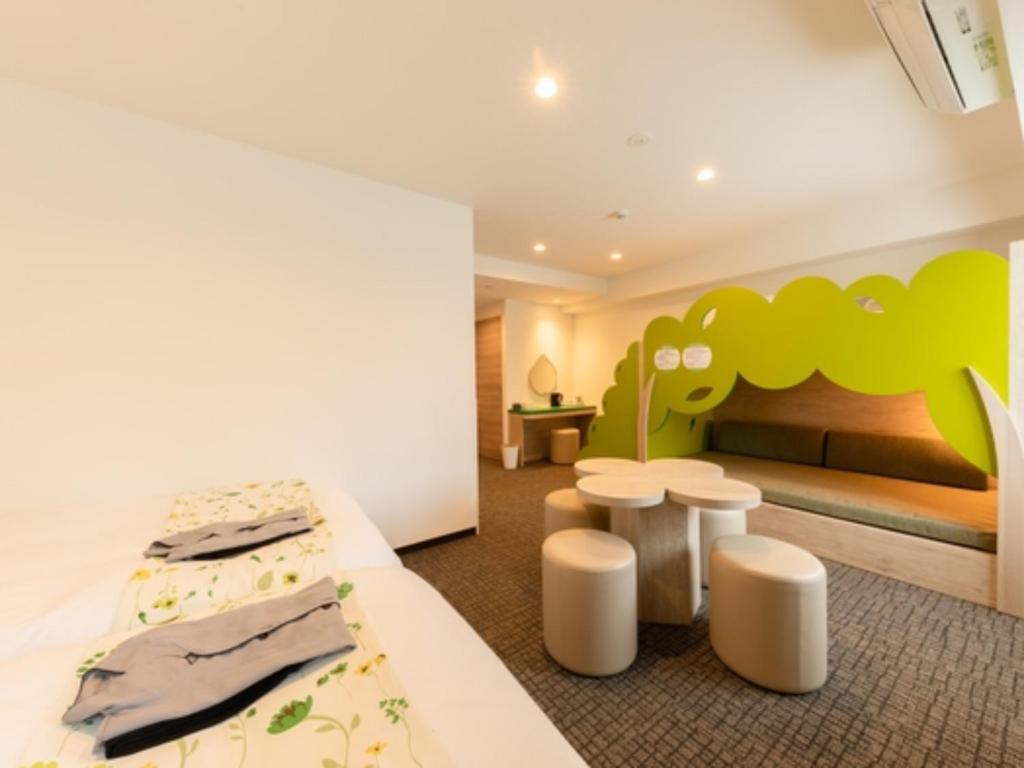 a hotel room with a bed and two stools at Hotel Torifito Kashiwanoha - Vacation STAY 75950v in Kashiwa