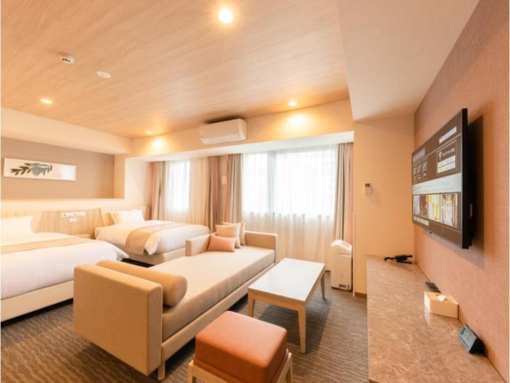 a hotel room with two beds and a tv at Hotel Torifito Kashiwanoha - Vacation STAY 75951v in Kashiwa