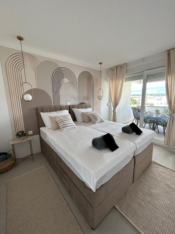 a large bedroom with a large bed with white sheets at Luxury apartment Golden Mint in Novalja