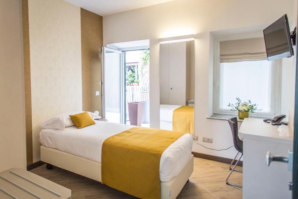 Postel nebo postele na pokoji v ubytování Hotel Ponti