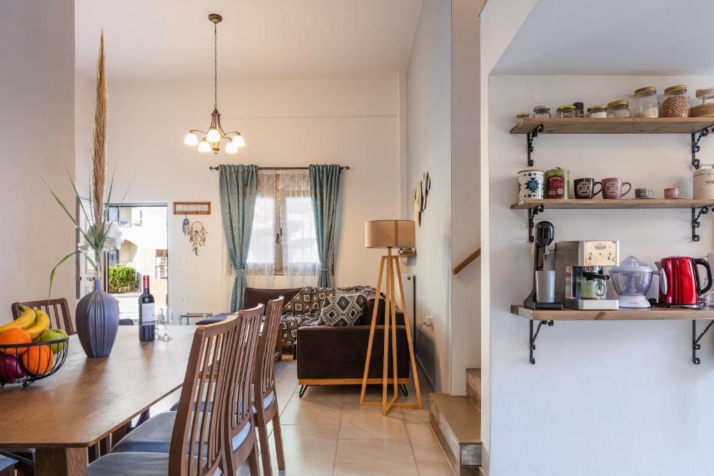 a dining room and living room with a table and chairs at Oddas Beach House in Rethymno Town