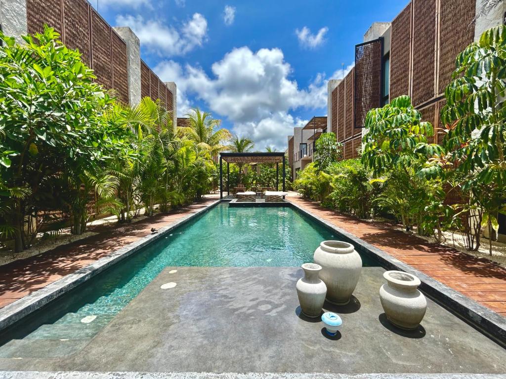 a swimming pool in the middle of a building at TOH Tulum - 2 Bedroom Apartments - Fiber WiFi in Tulum