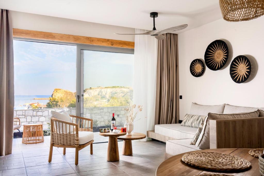 a living room with a view of the ocean at Lithos Luxury Villa in Archangelos