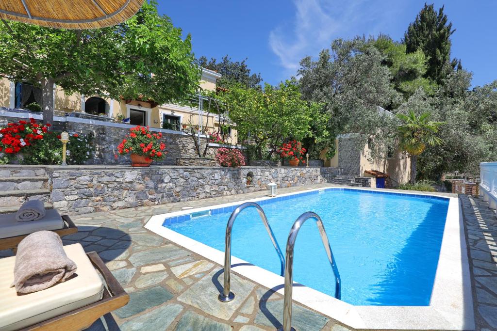 a swimming pool in a yard with a house at Villa Potami in Agnontas