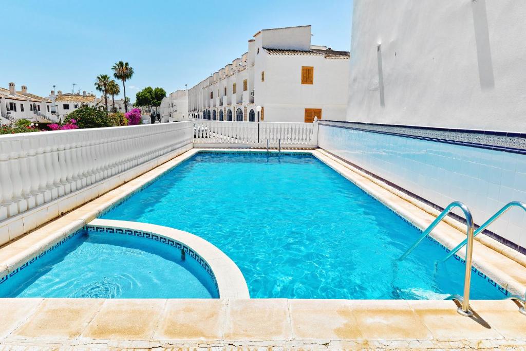 a swimming pool in the middle of a building at Espanhouse Alina in Orihuela Costa