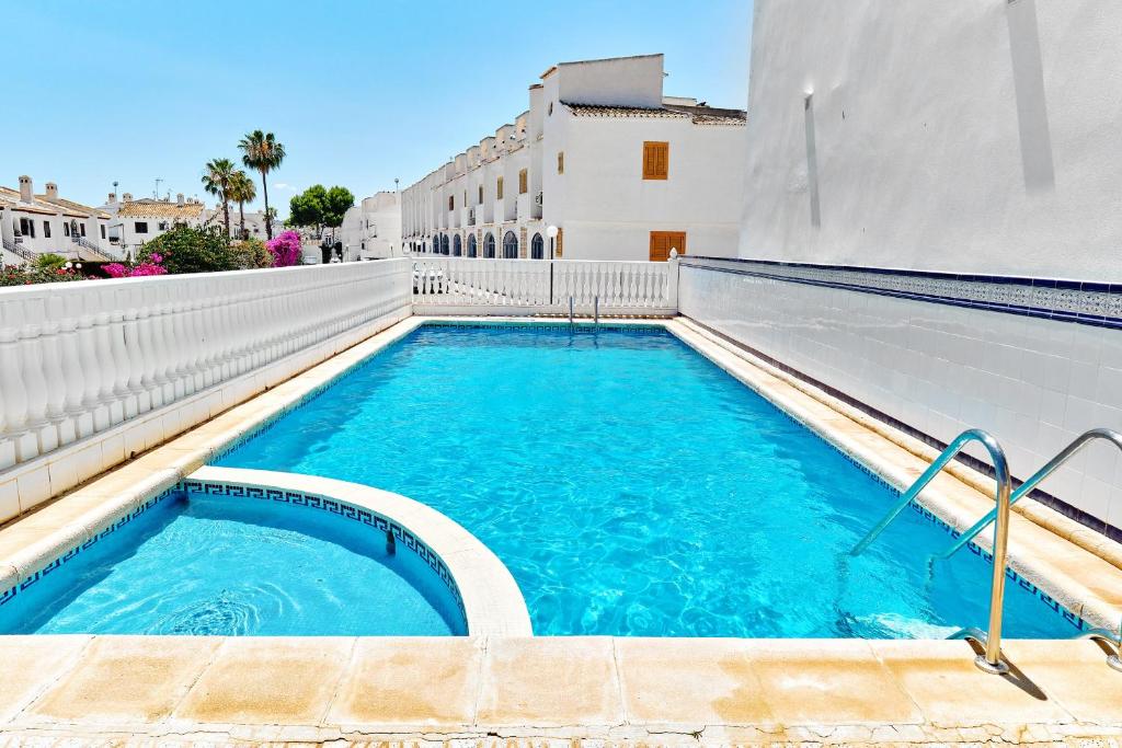 a swimming pool on the side of a building at Espanhouse Sonia in La Zenia Playas de Orihuela in Orihuela