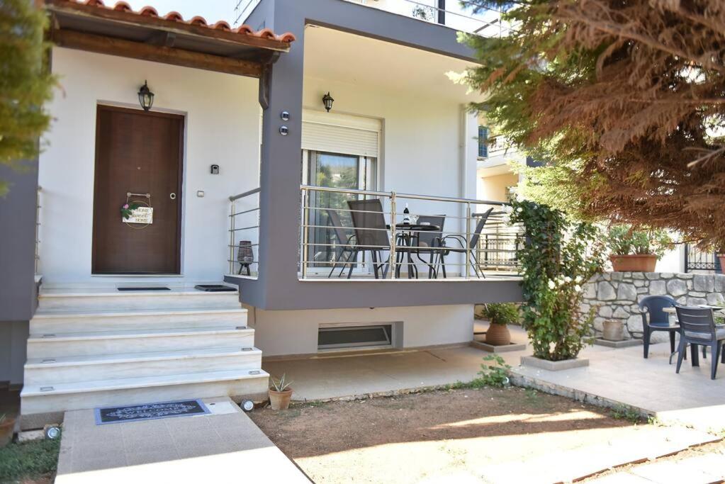 a house with a balcony and a patio at Villa Emmanuel in Karteros