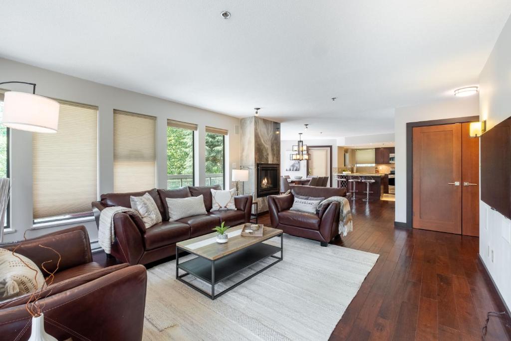 a living room with couches and a table at Greyhawk 123 by Outpost Whistler in Whistler