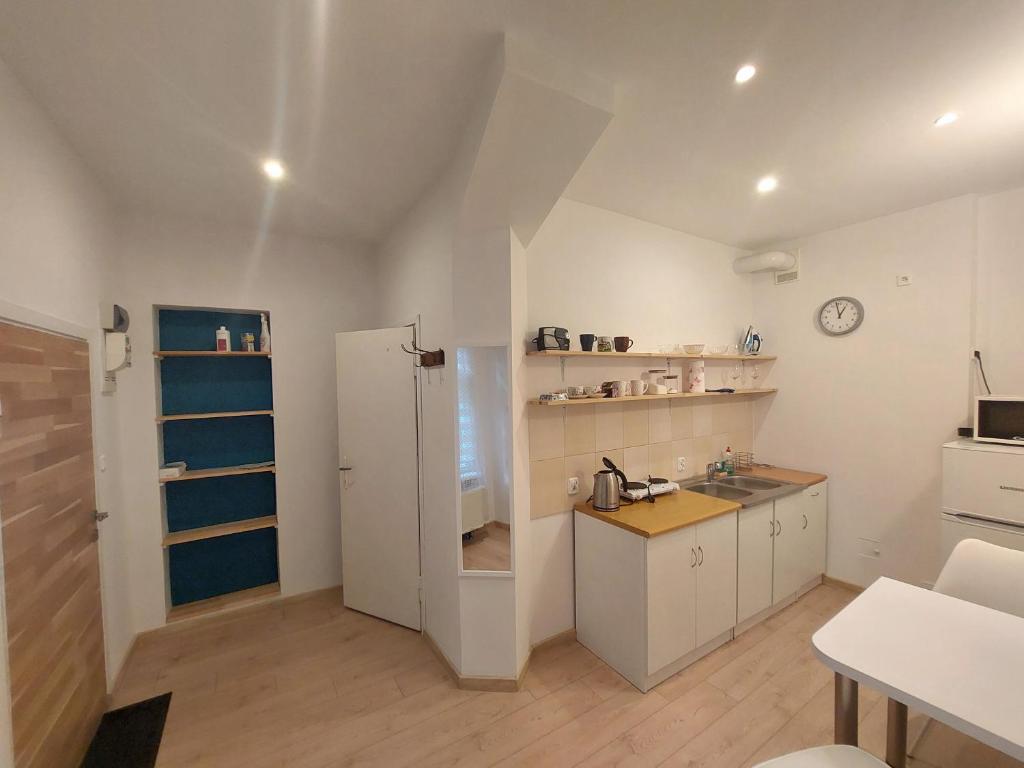 a kitchen with a white refrigerator and a sink at Kawalerka w centrum Sopotu in Sopot