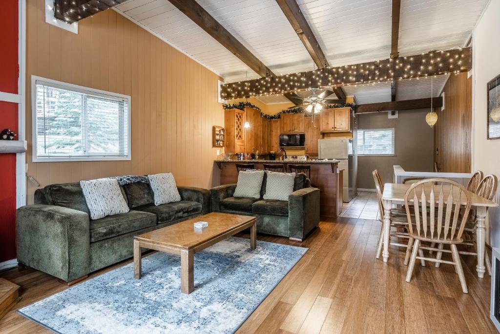 a living room with a couch and a table at Tyrolean Village 6 2 Bedroom 1 and a Half Bath Sleeps 6 Walk to Lift Steps to town shuttle in Mammoth Lakes