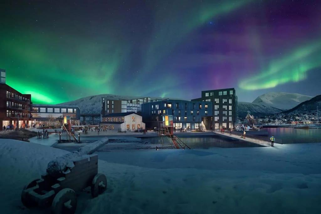 an image of a city with the aurora in the sky at Vervet apartment in Tromsø