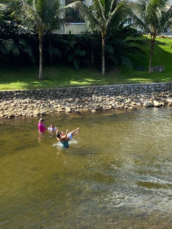 a group of people swimming in the water at Recanto Paraíso da Mih in Paraty