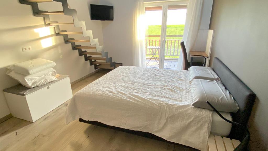 Postel nebo postele na pokoji v ubytování B&B Les Autres Sens