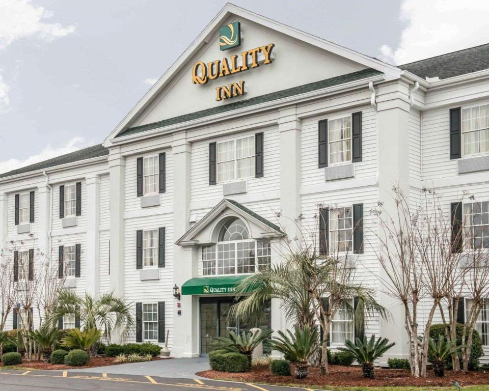 a white inn with a sign on the front of it at Quality Inn Lake City in Lake City