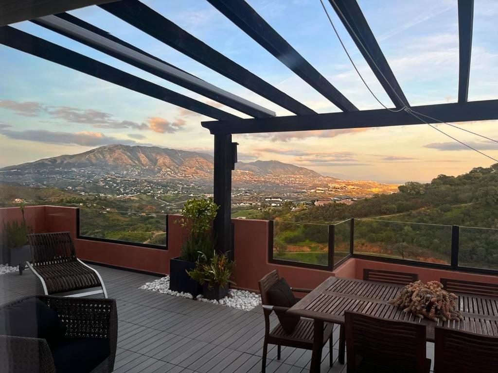 d'un balcon avec une table et des chaises et une vue. dans l'établissement Bright apartment in the hills of Elviria, à Malaga