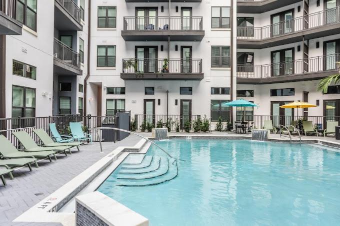 a large swimming pool in front of a building at Luxury Condo in Ybor City Tampa w/Pool access in Tampa