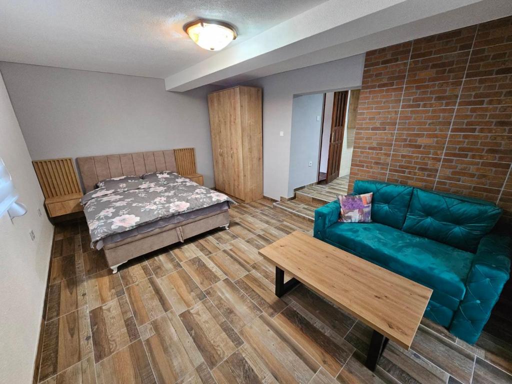 a living room with a couch and a bed at City View Apartment in Bijelo Polje