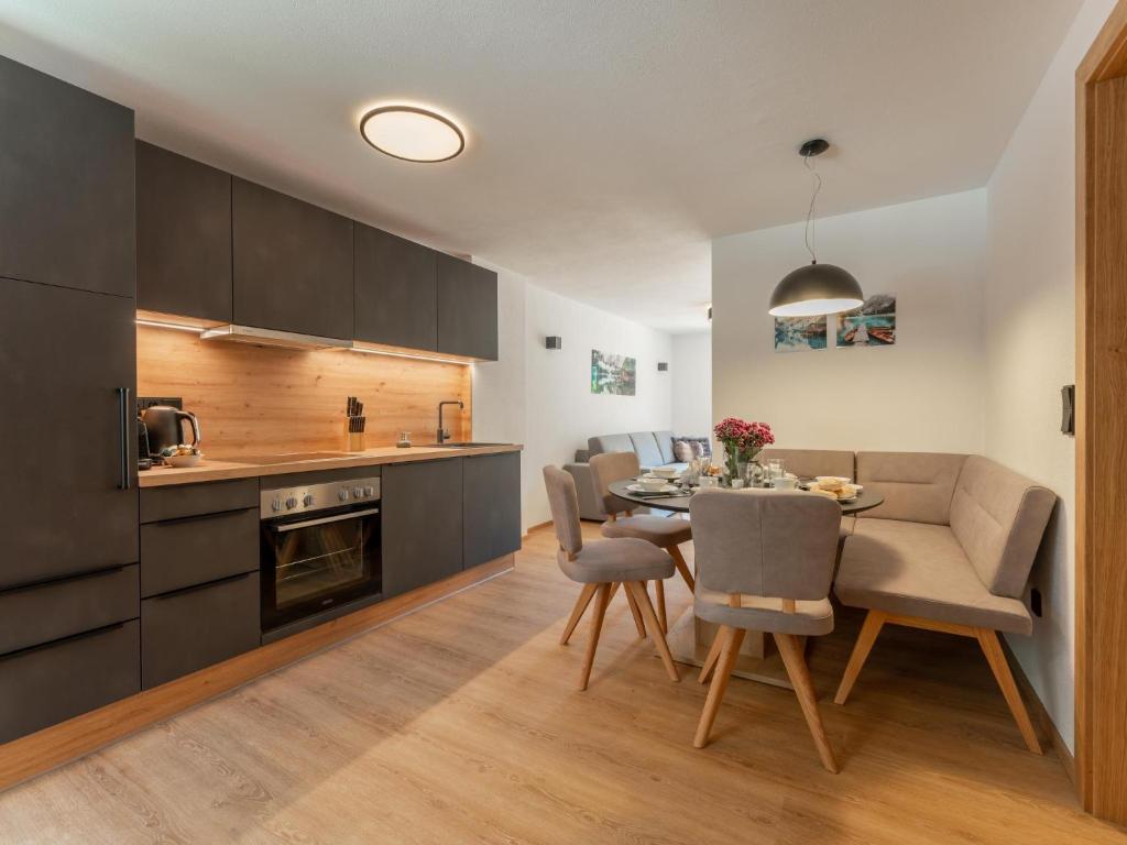 a kitchen and dining room with a table and chairs at Villa Felding Top 4 in Bad Hofgastein