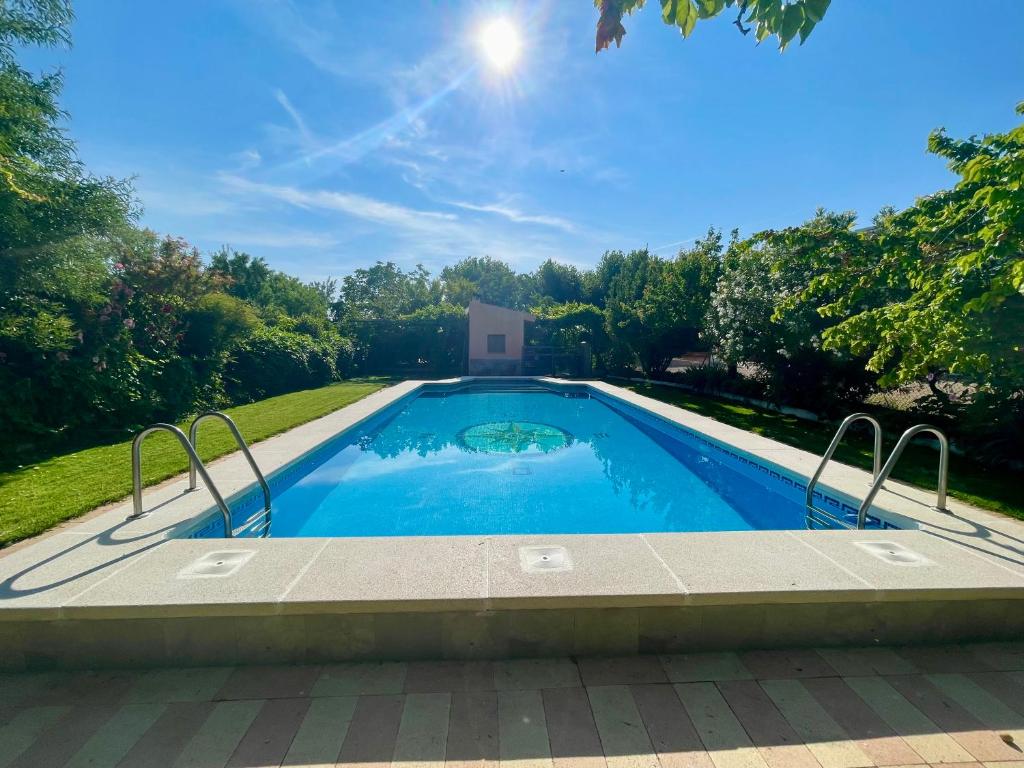 a swimming pool in the middle of a yard at CASA RURAL DOÑA LUCINDA in Albacete