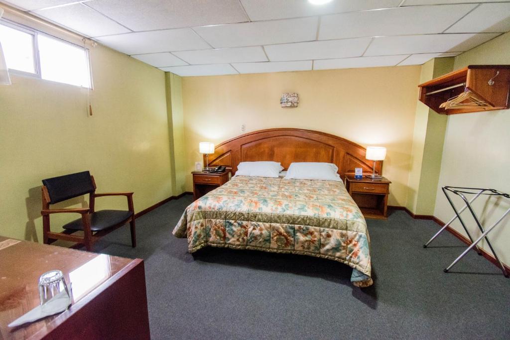 Postel nebo postele na pokoji v ubytování Grand Hotel Loja