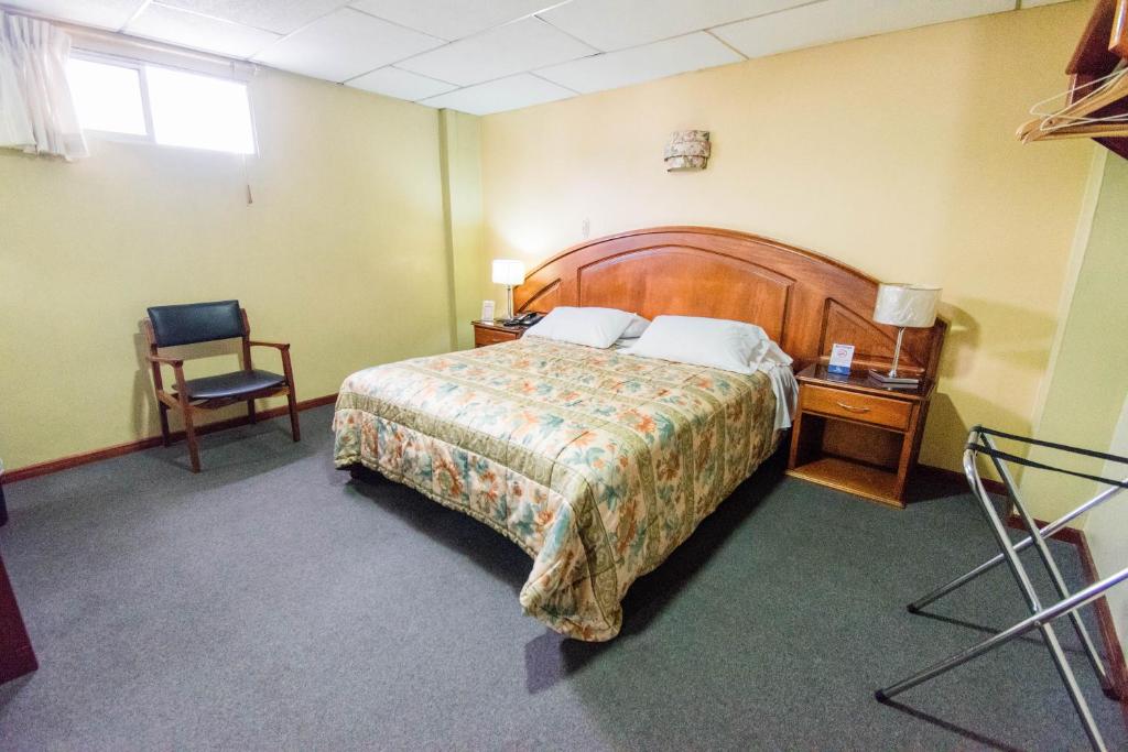 Postel nebo postele na pokoji v ubytování Grand Hotel Loja