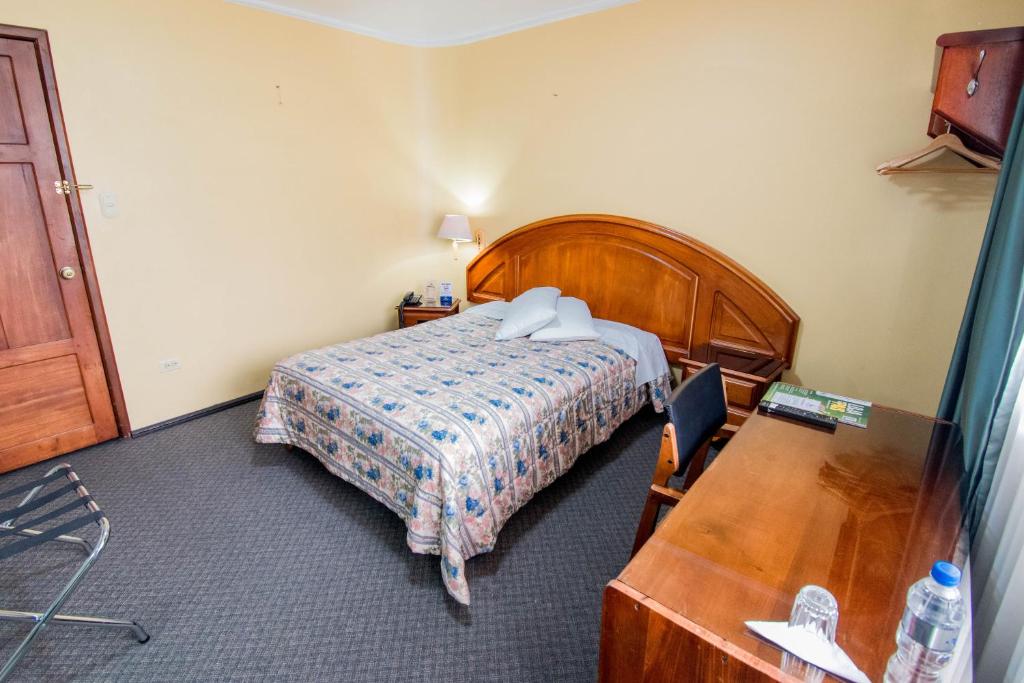 Postel nebo postele na pokoji v ubytování Grand Hotel Loja