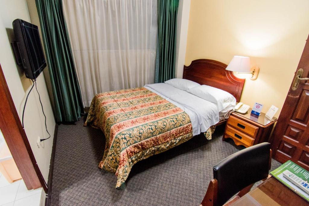 Postel nebo postele na pokoji v ubytování Grand Hotel Loja