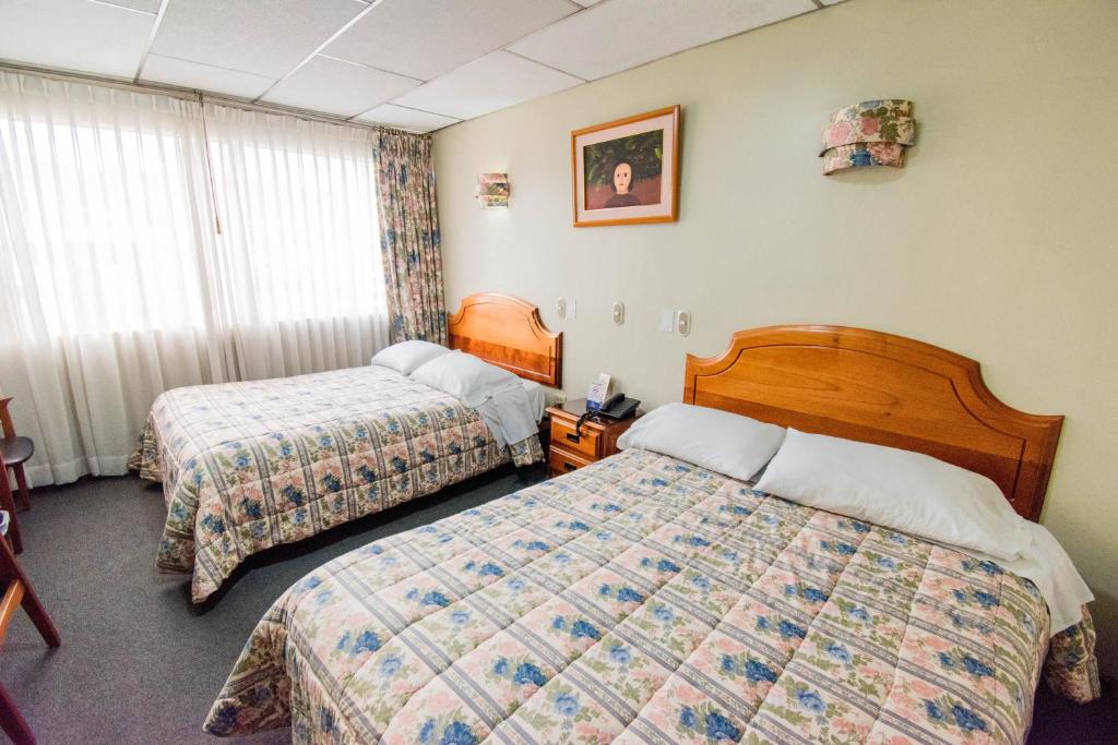 Postel nebo postele na pokoji v ubytování Grand Hotel Loja
