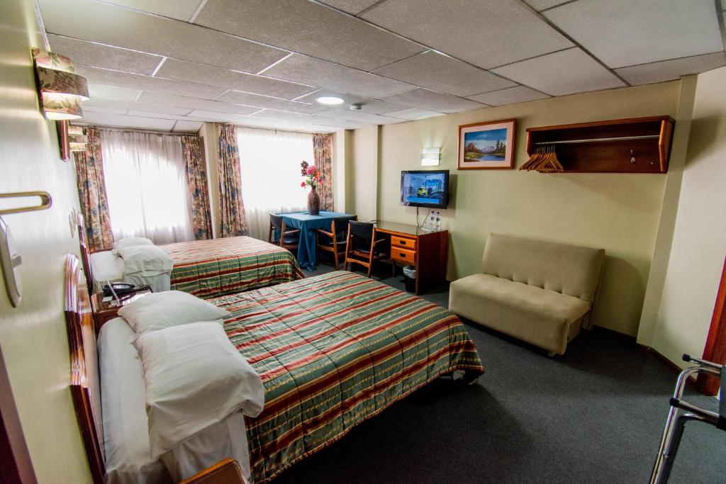 Postel nebo postele na pokoji v ubytování Grand Hotel Loja