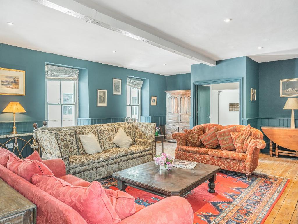 a living room with couches and a table at The Old Brewery in Pembroke