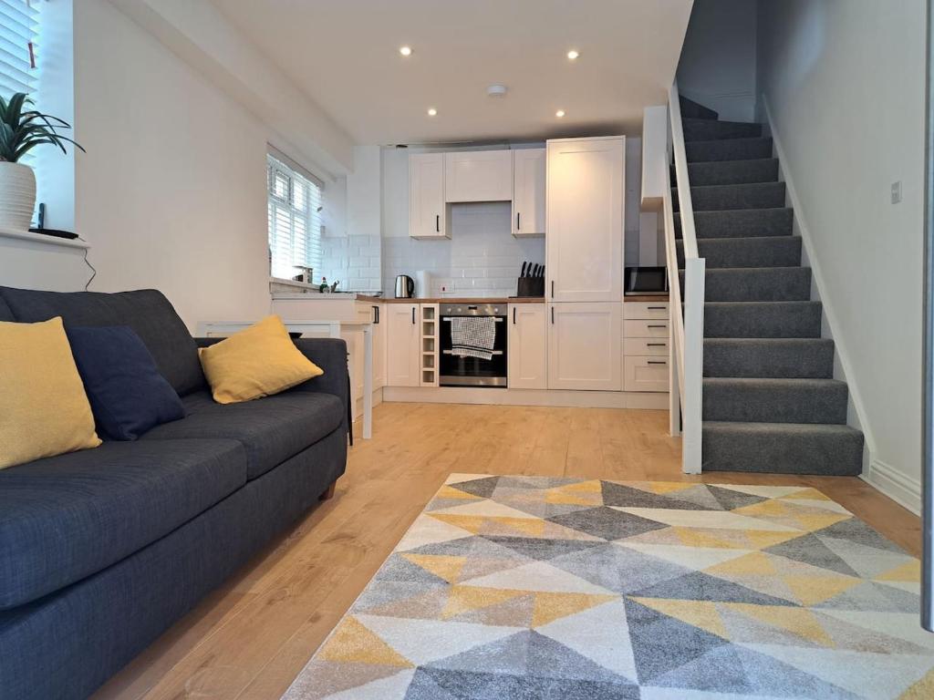 a living room with a couch and a staircase at Modern city house in Southampton