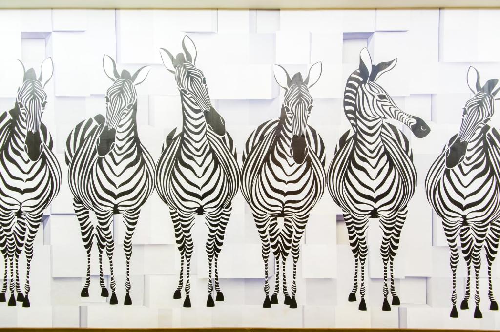 a group of zebras standing in a row at Sanduo Hotel in Kaohsiung