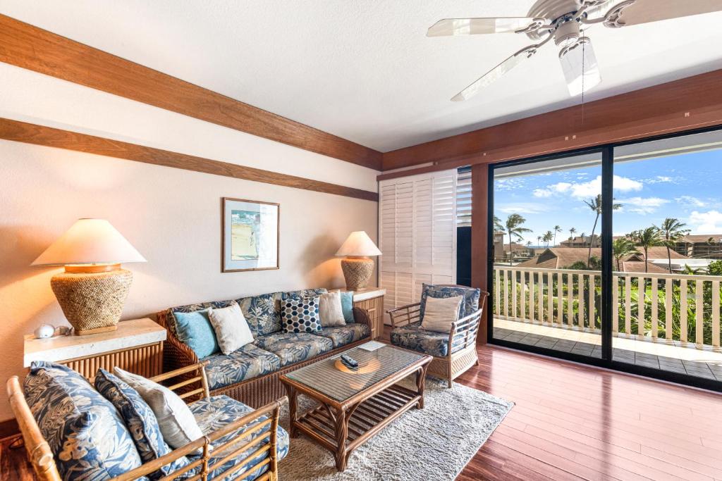 a living room with a couch and a table at Partial Oceanview 1BR at Kiahuna Plantation Unit 311 in Koloa