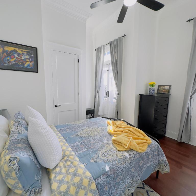 a bedroom with a bed with a cat laying on it at Walk to French Quarter House of Jazz & Blue Suite in New Orleans