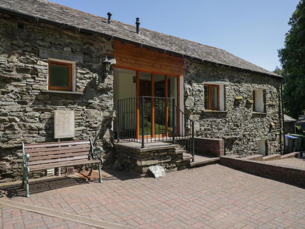 a stone building with a bench in front of it at Swallow's Nest in Keswick