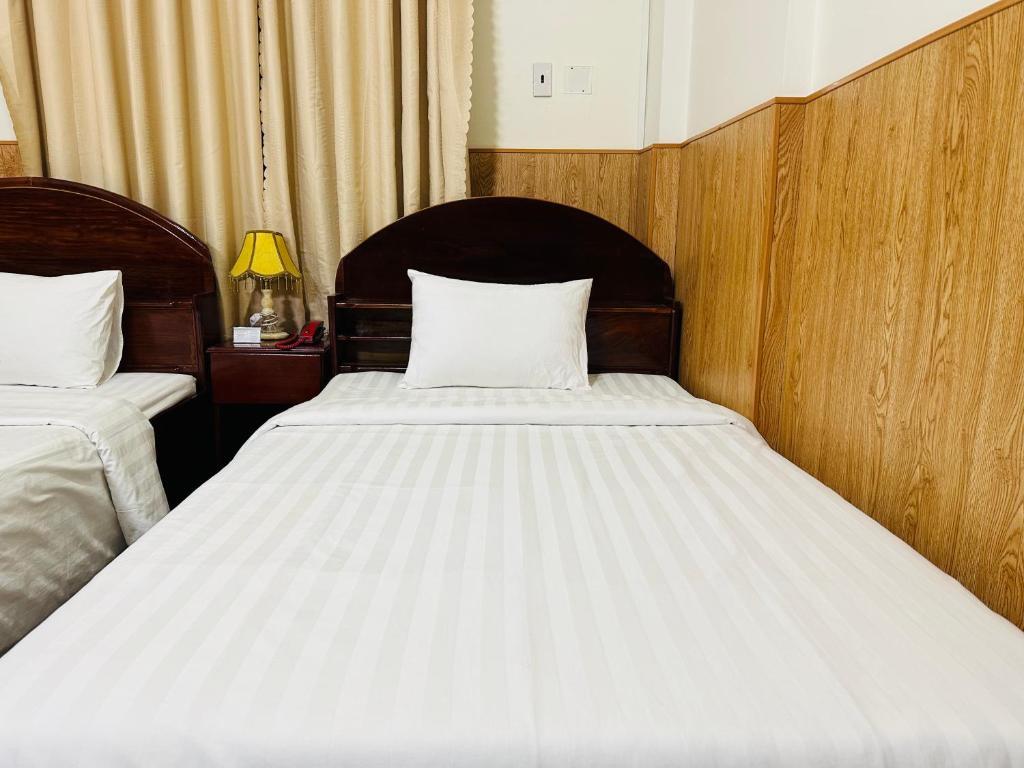Postel nebo postele na pokoji v ubytování Khách sạn Mekong Star
