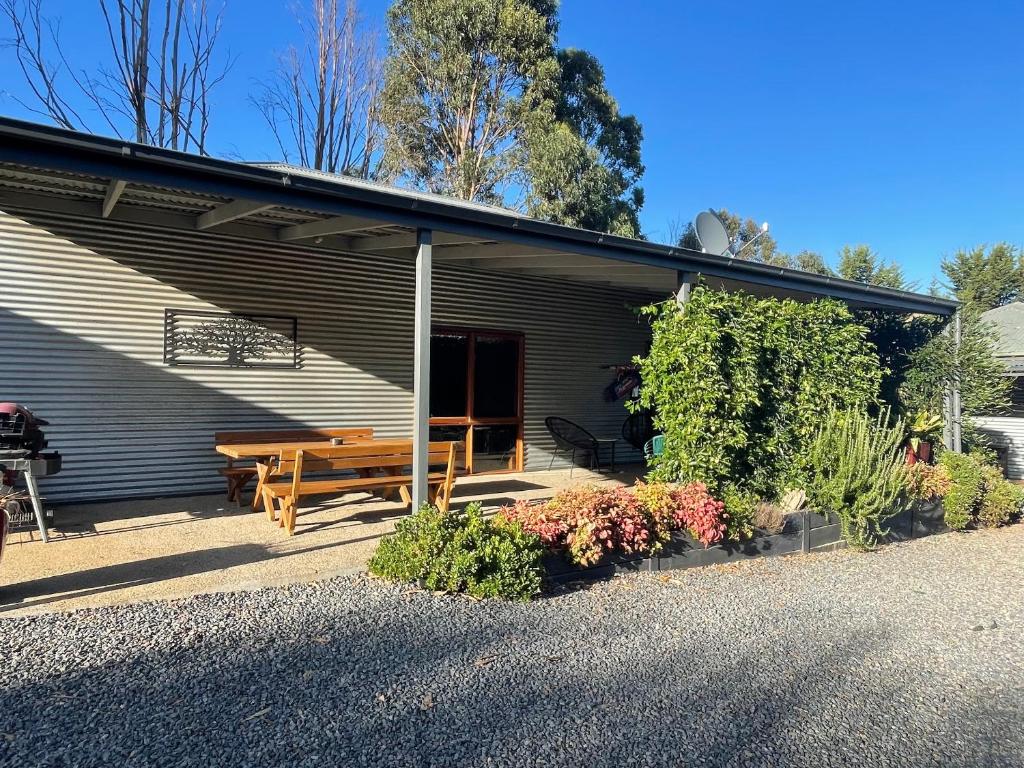 a house with a picnic table in front of it at Omaroo High Country Retreat in Bonnie Doon