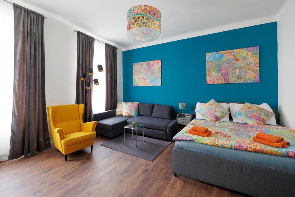 ein Wohnzimmer mit einem Sofa und einer blauen Wand in der Unterkunft NEW ShalalaLiving Vienna Spacious Home for Family & Friends in Wien