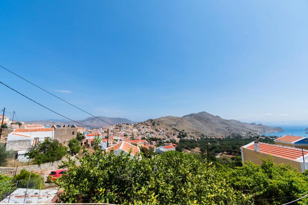 a view of a city with mountains and the ocean at EIRINI in Symi