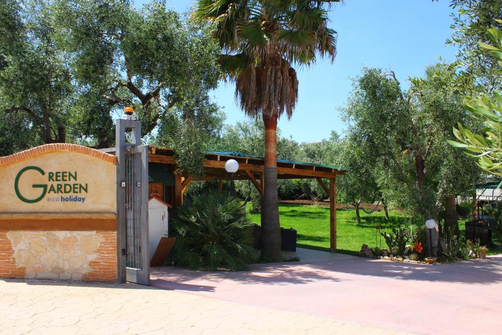 a sign for a new aduana park with a palm tree at Green Garden Eco-Holiday in Vieste